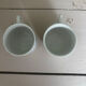 Set of 3 antique ceramic cups with blue floral pattern.