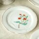 Tableware set in earthenware with floral decoration.