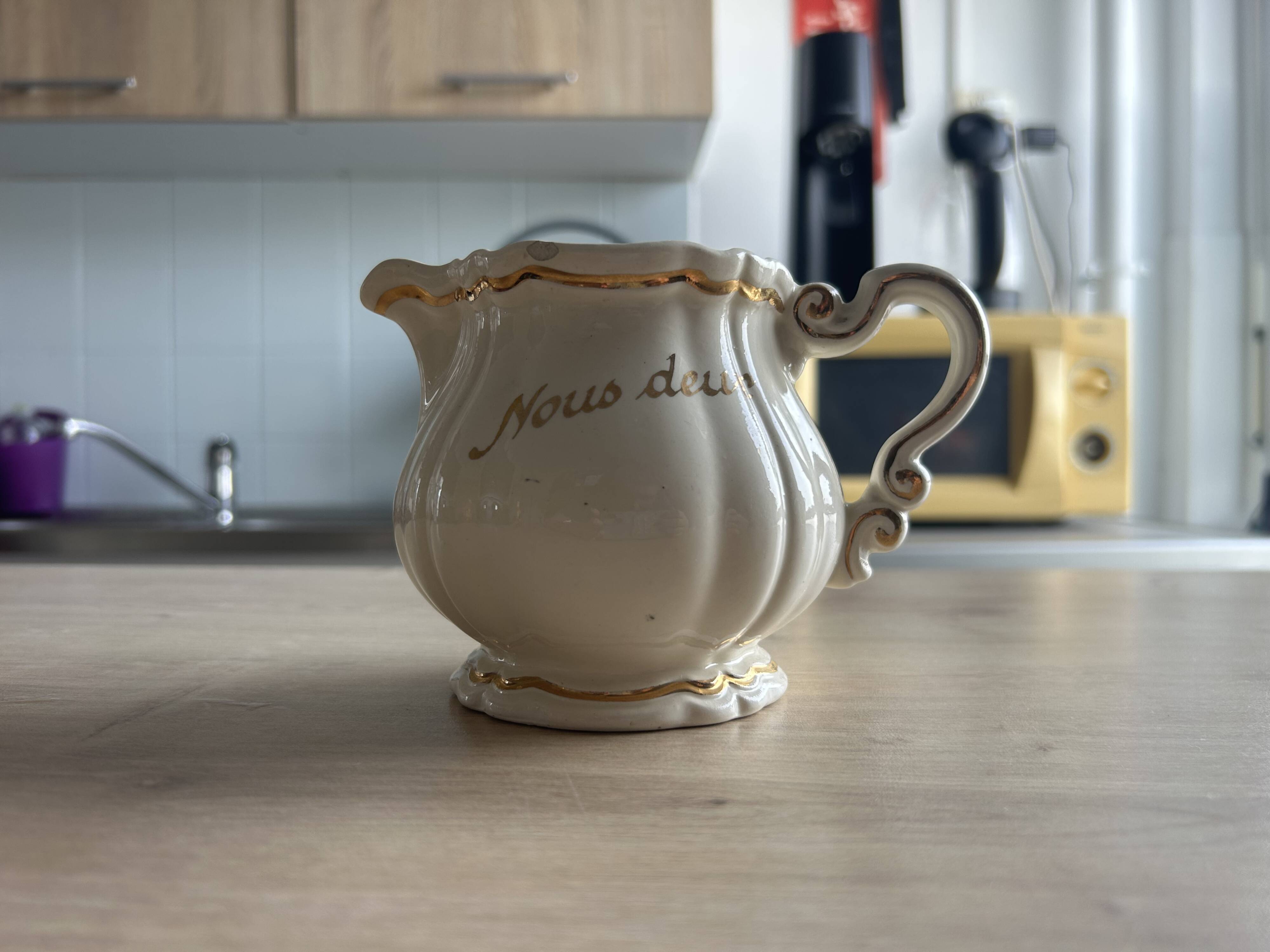 Old cream jug "Nous deux" in Sarreguemines earthenware.