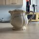 Old cream jug "Nous deux" in Sarreguemines earthenware.