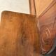 Antique carved wooden dressing table with marble and tilting oval mirror.
