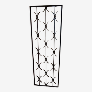 Rectangular decorative wrought iron gate initially on a door