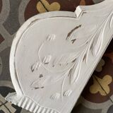 White patinated wooden pediment.
