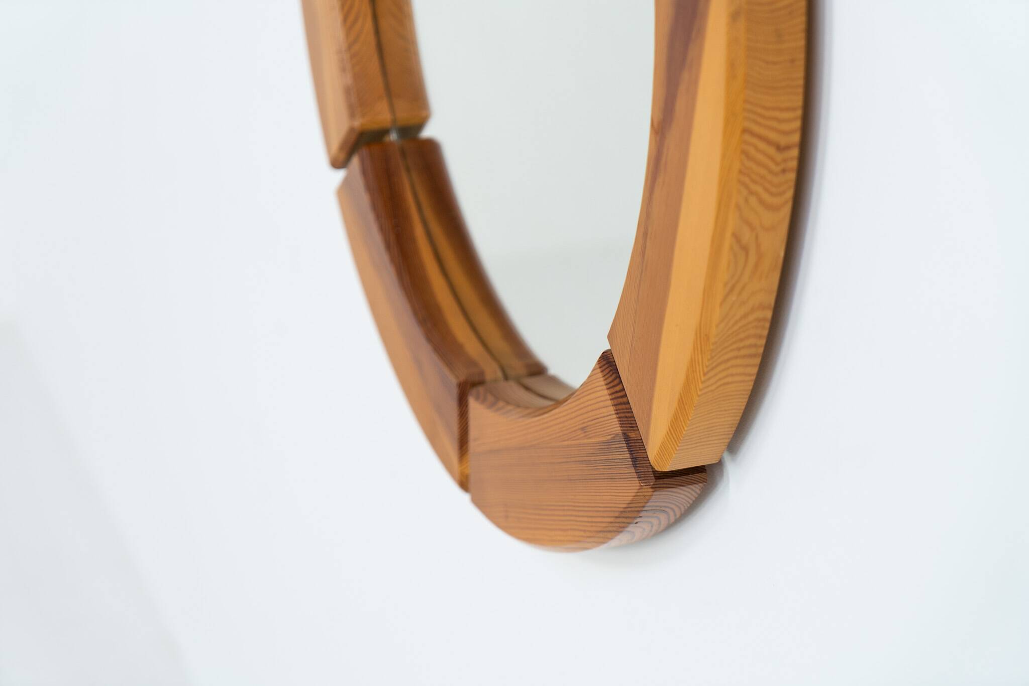 Sculptural wall mirror in solid pine