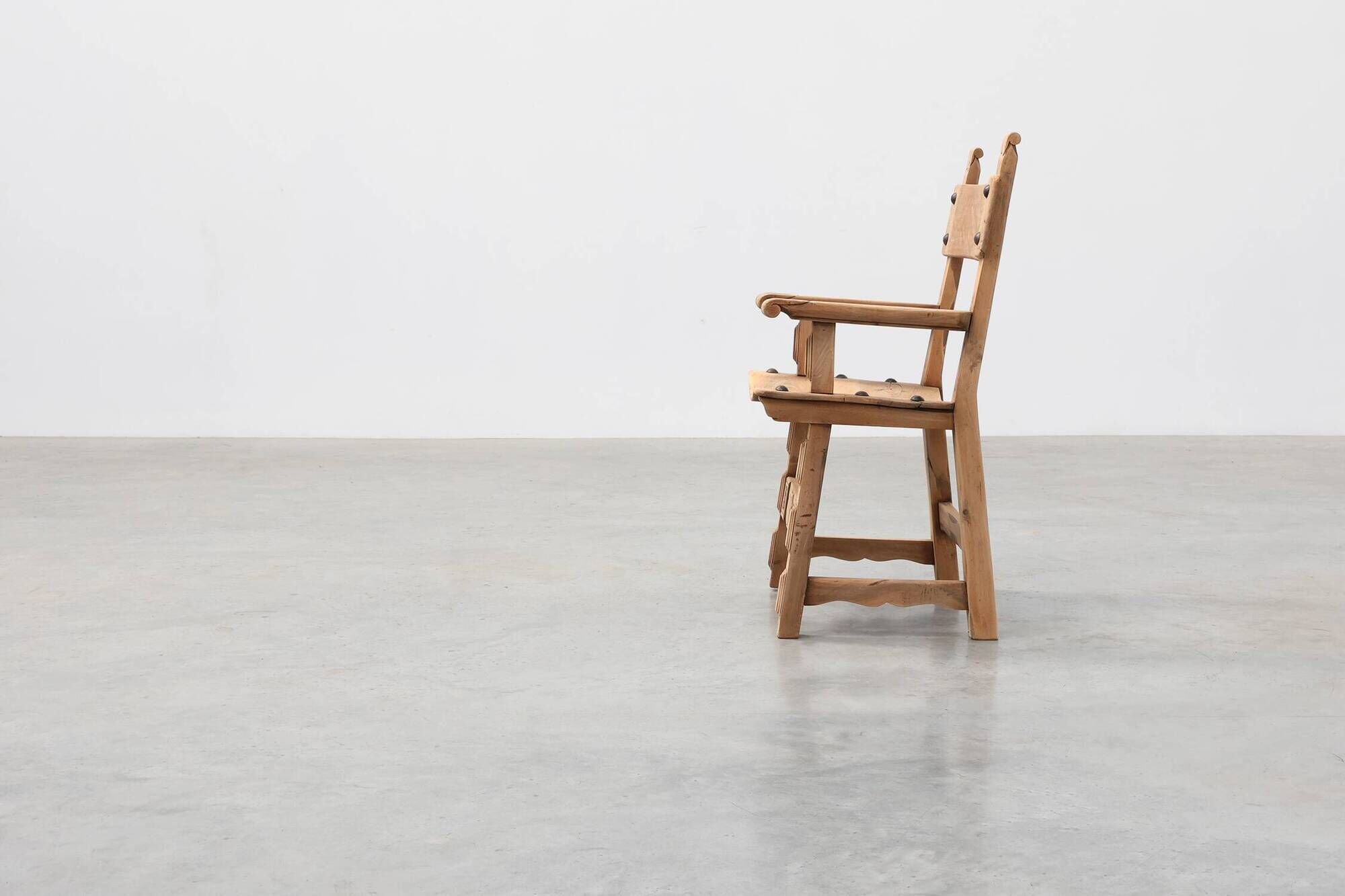 Brutalist armchair with carved rosettes and nailed wooden seat, Spain