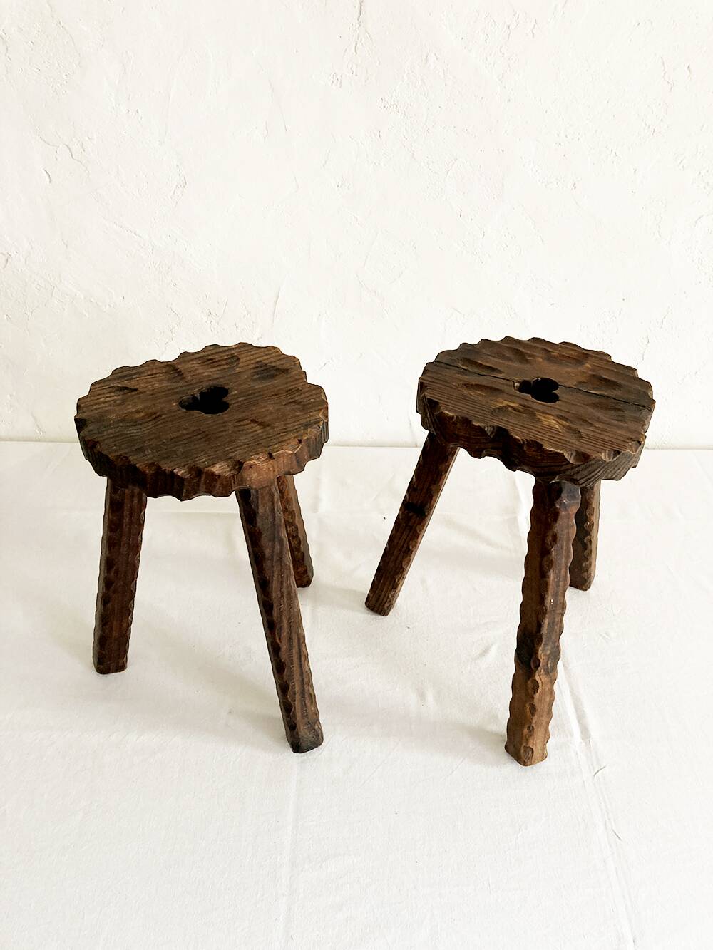 Pair of tripod farmhouse stools with clover pattern