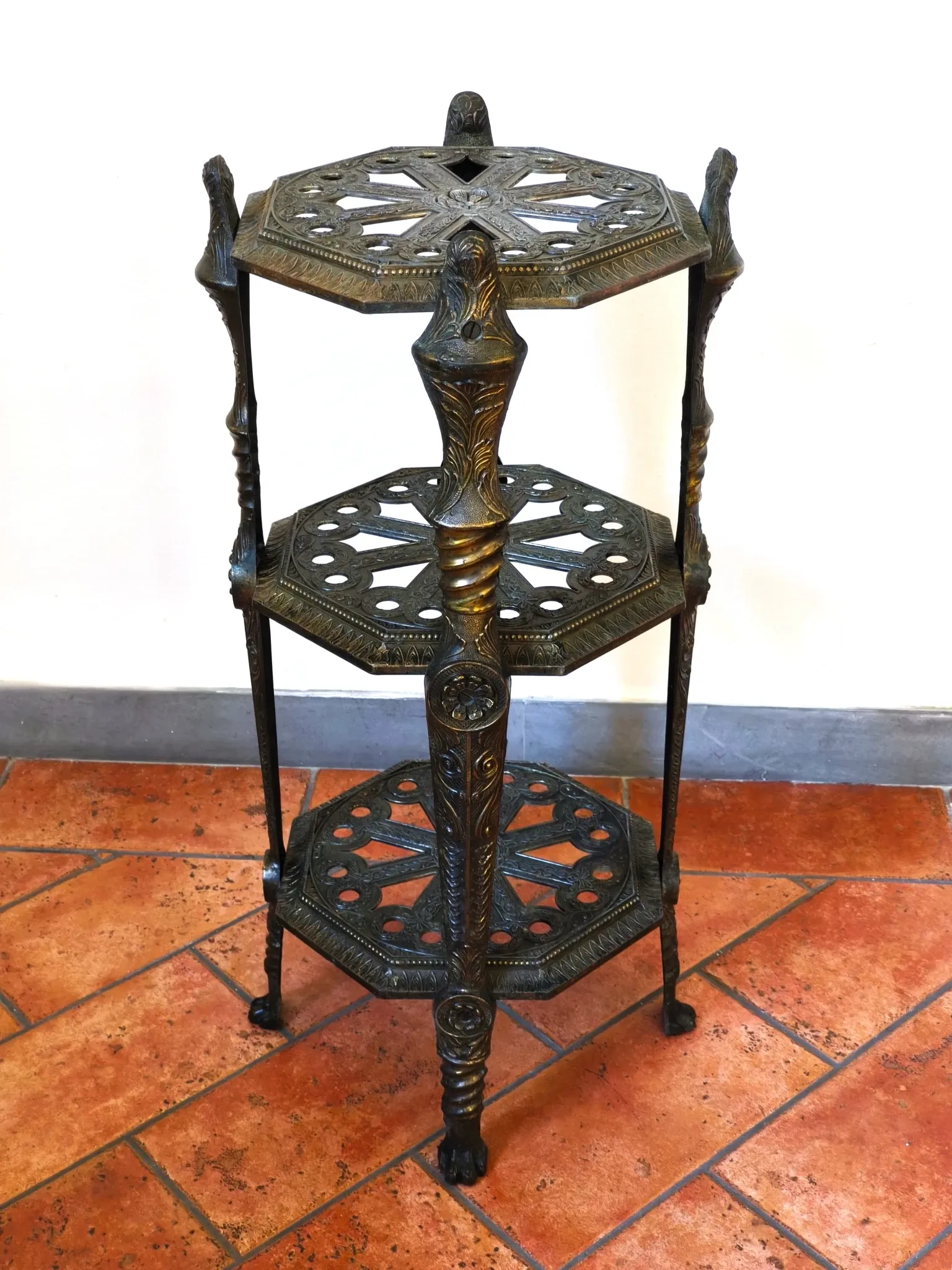 Italian side table with three openwork shelves in patinated metal.