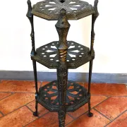 Italian side table with three openwork shelves in patinated metal.