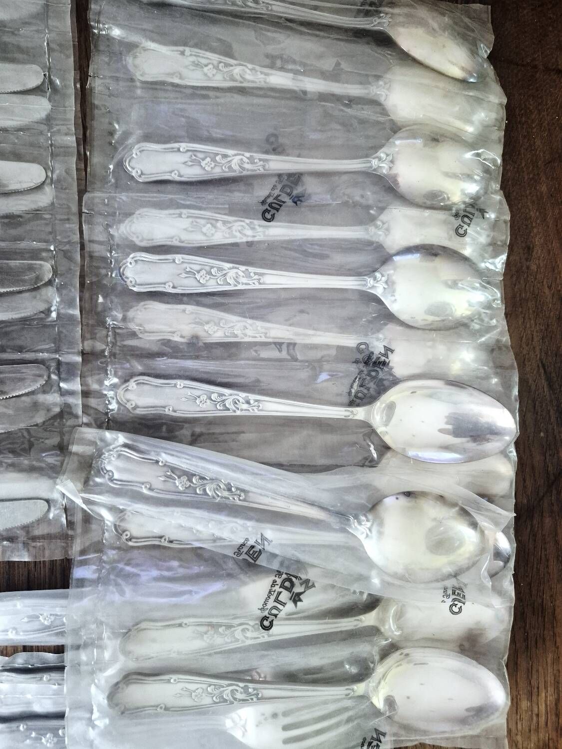 48 new silver-plated metal cutlery pieces in blister packaging.