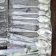 48 new silver-plated metal cutlery pieces in blister packaging.