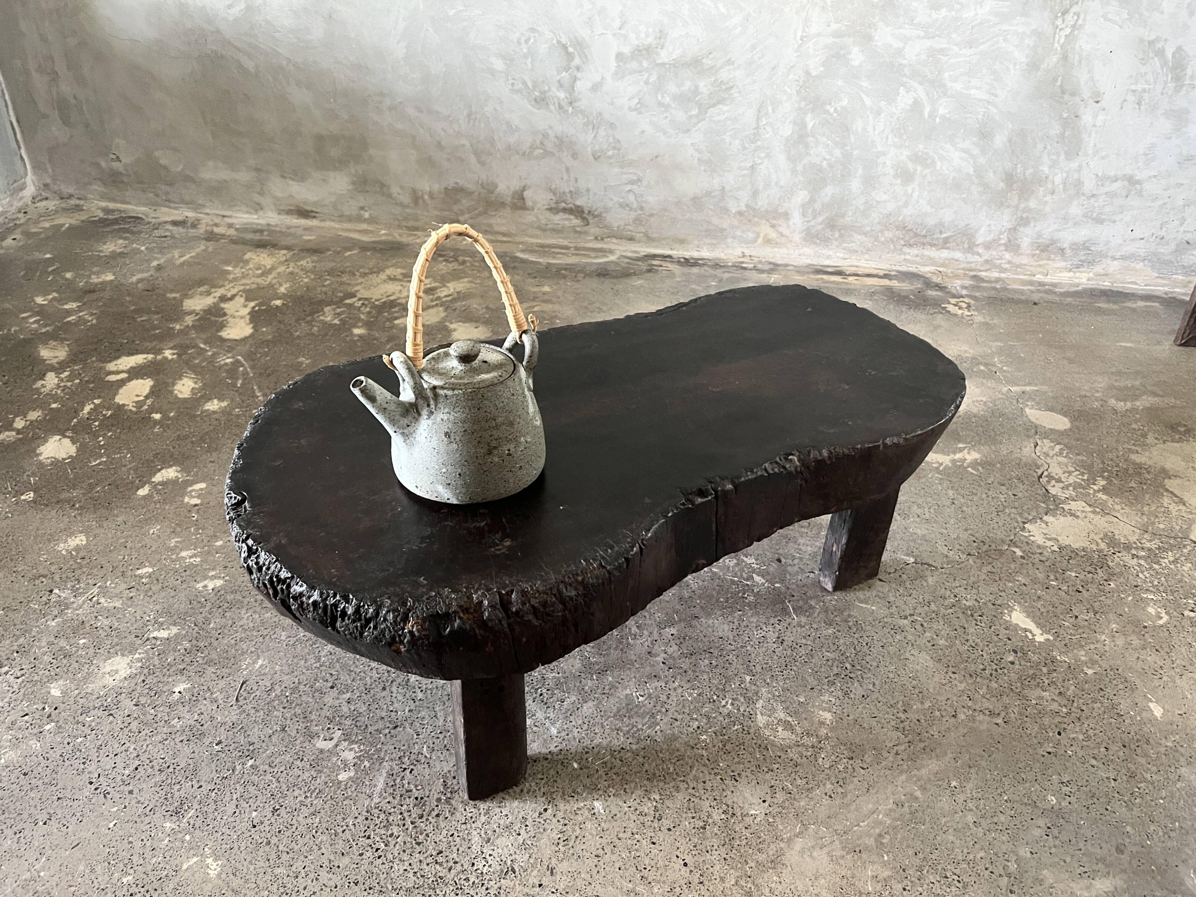 Small old Asian wooden coffee table in Japanese style, kidney-shaped top