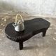 Small old Asian wooden coffee table in Japanese style, kidney-shaped top