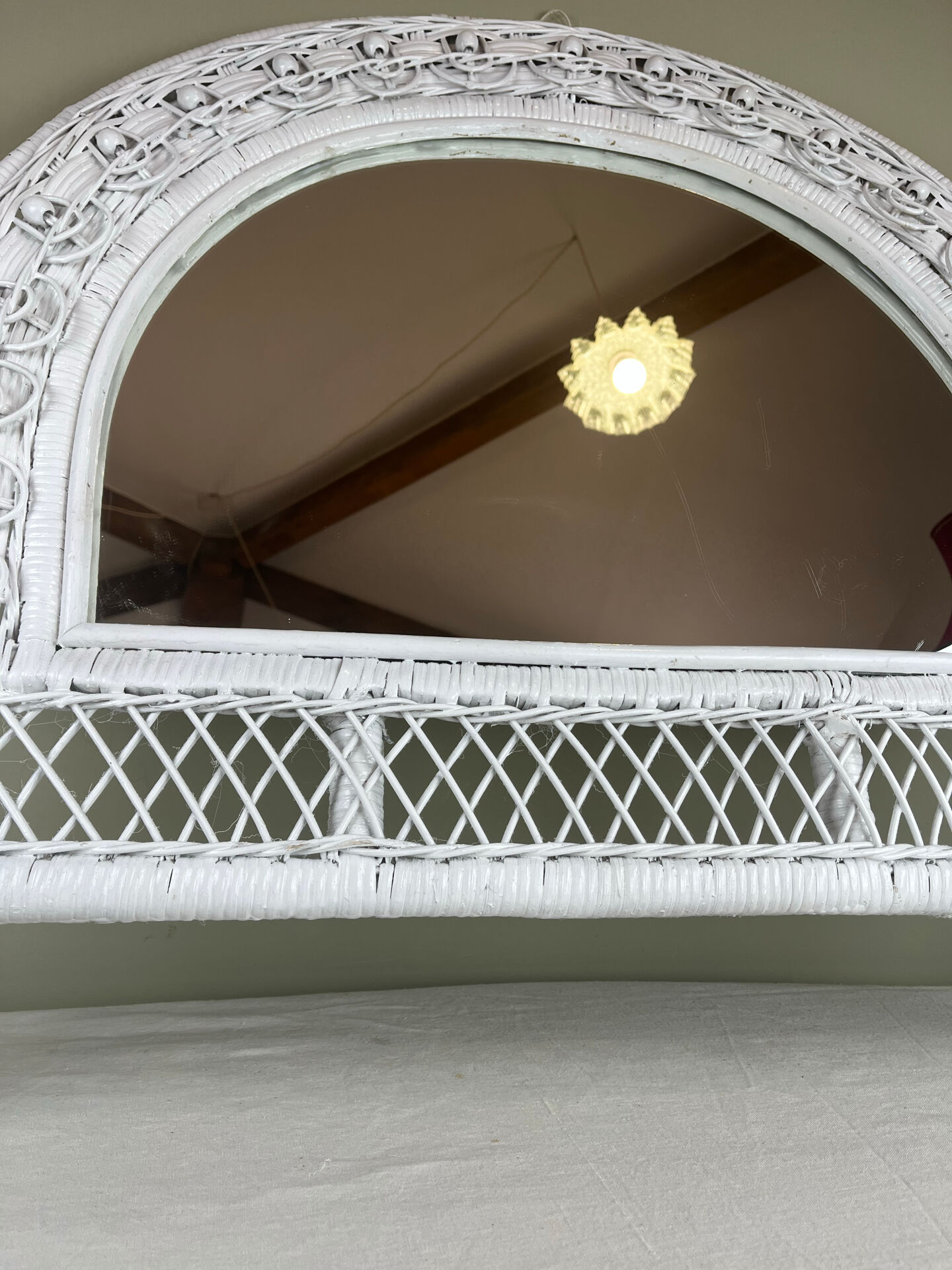 Half-moon wicker mirror