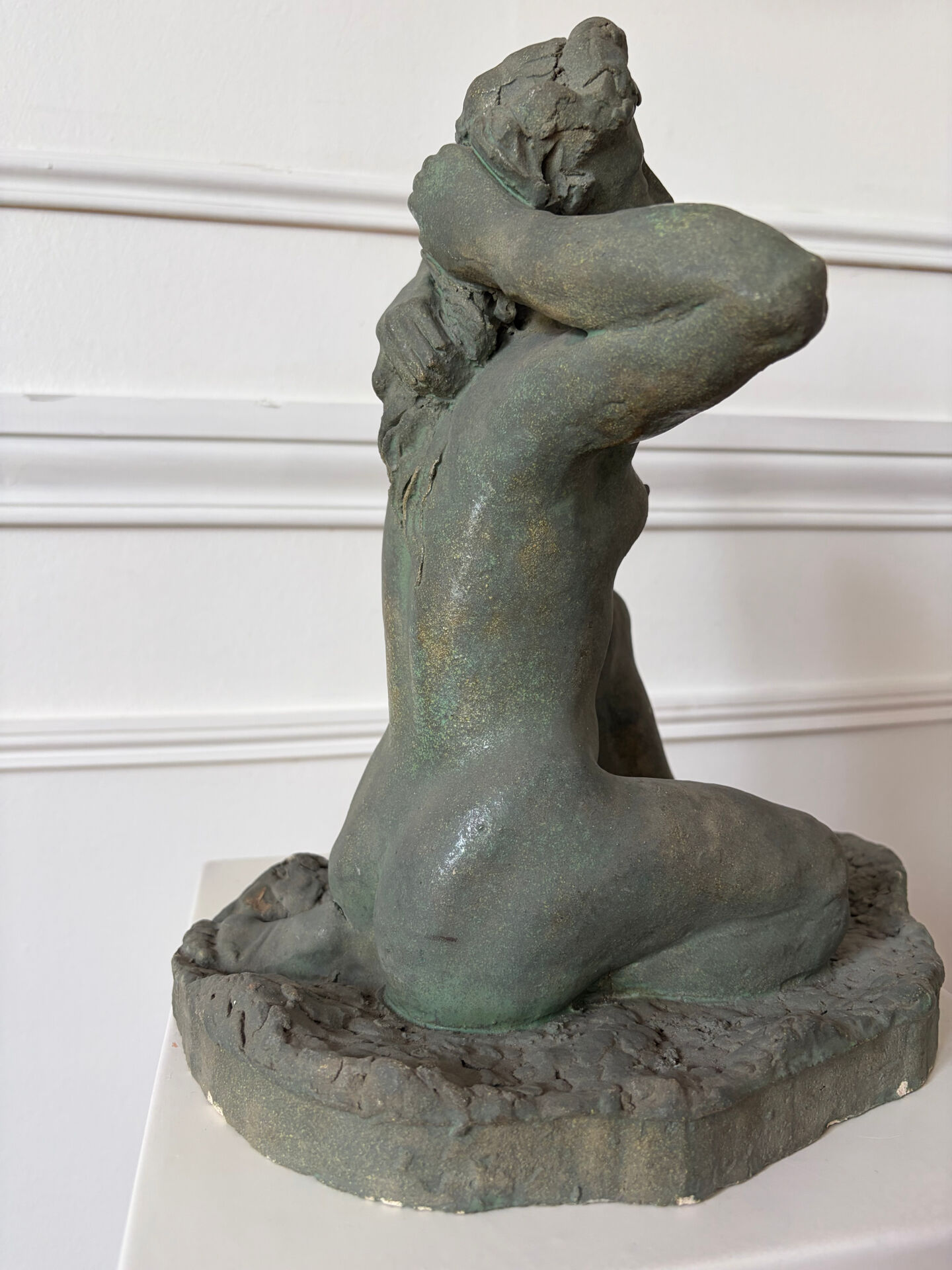 Sculpture of a naked woman titled "Youth" in terracotta.