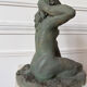 Sculpture of a naked woman titled "Youth" in terracotta.