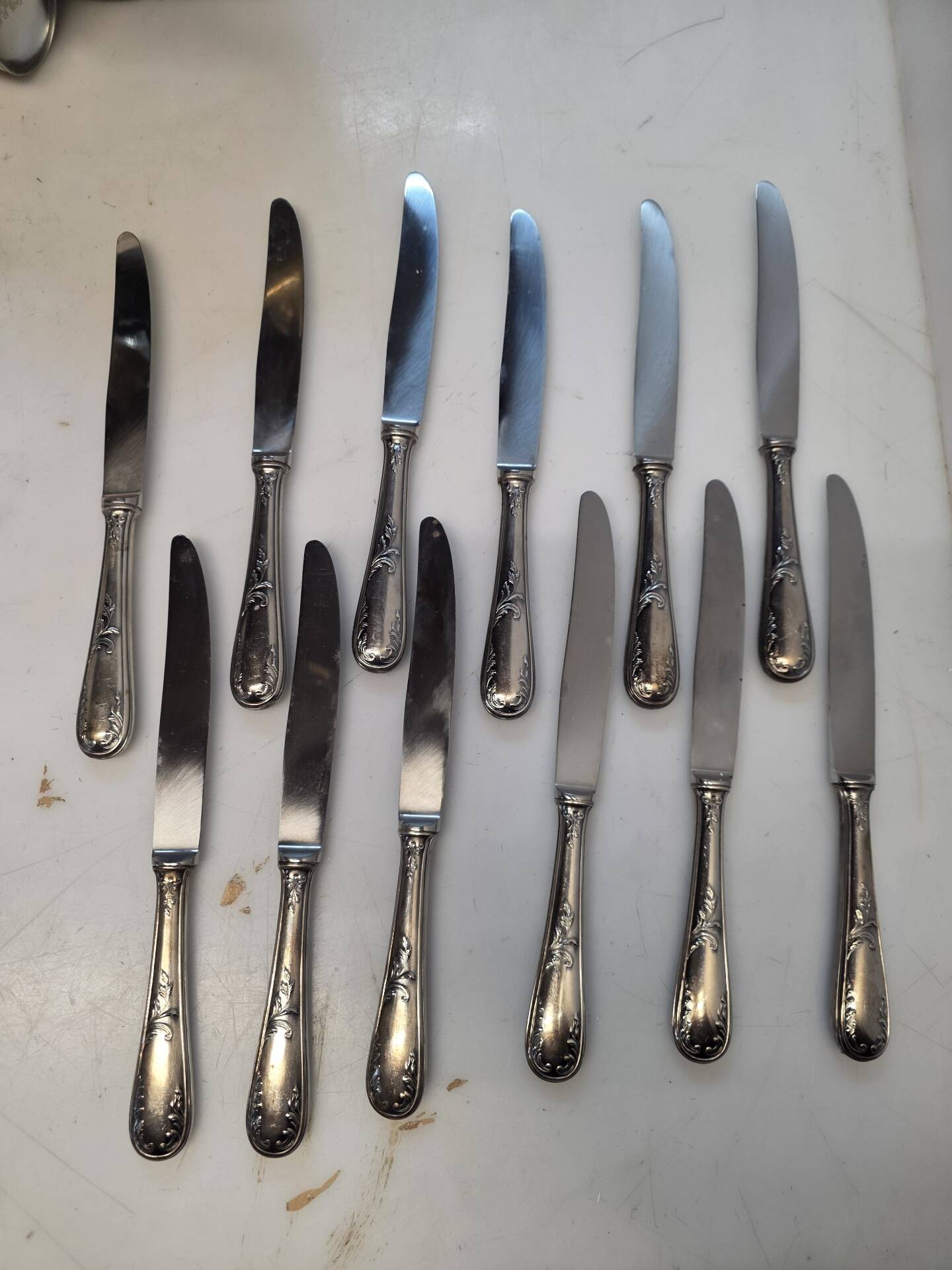 12 silver-plated metal knives from the mid-20th century