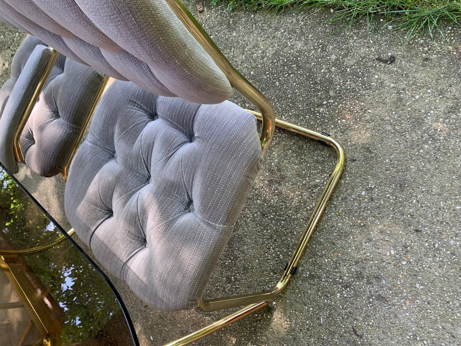 1970s table set with 4 chairs in gold brass and grey fabric, smoked glass top.