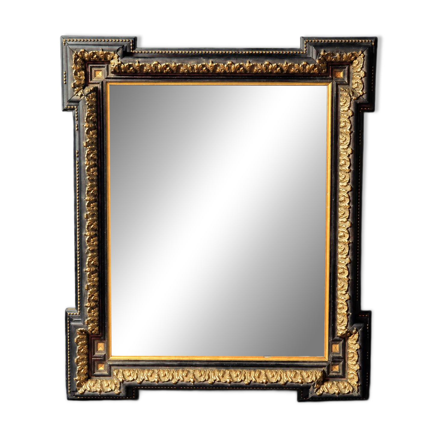 Napoleon III mirror in blackened wood and gilded decoration, second half of the 19th century.
