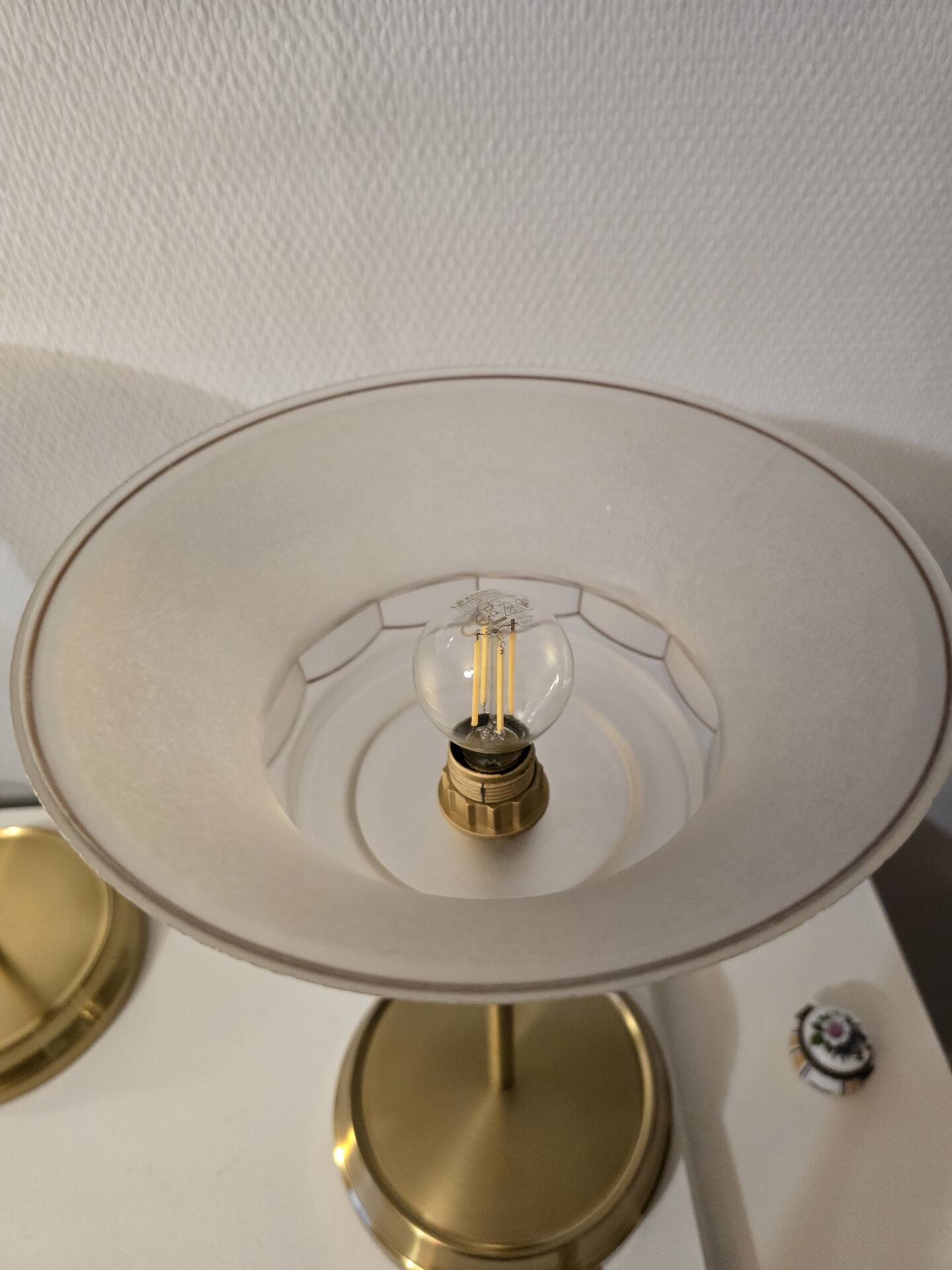 Art Deco table lamps with frosted glass shade and brass base.