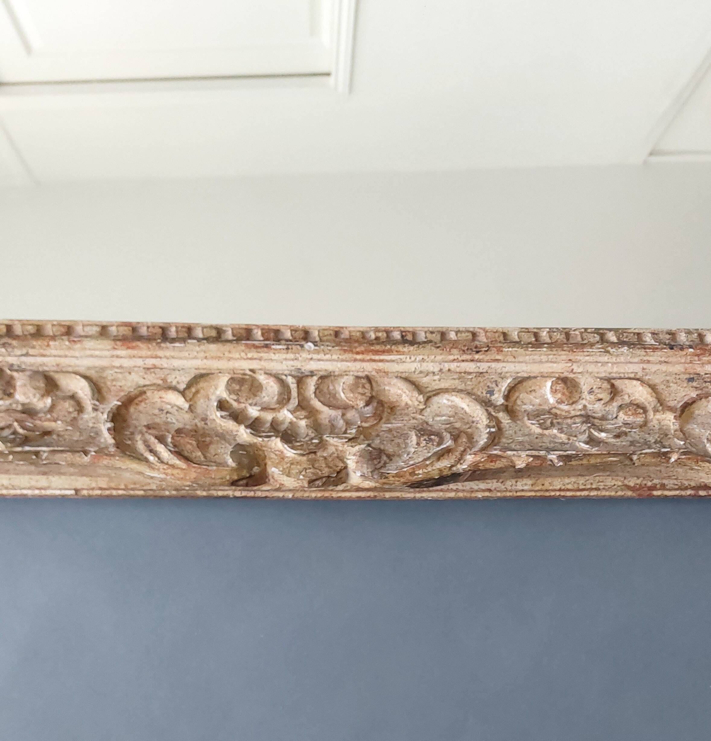 Large Montparnasse rocaille style frame in carved wood mounted in mirror.
