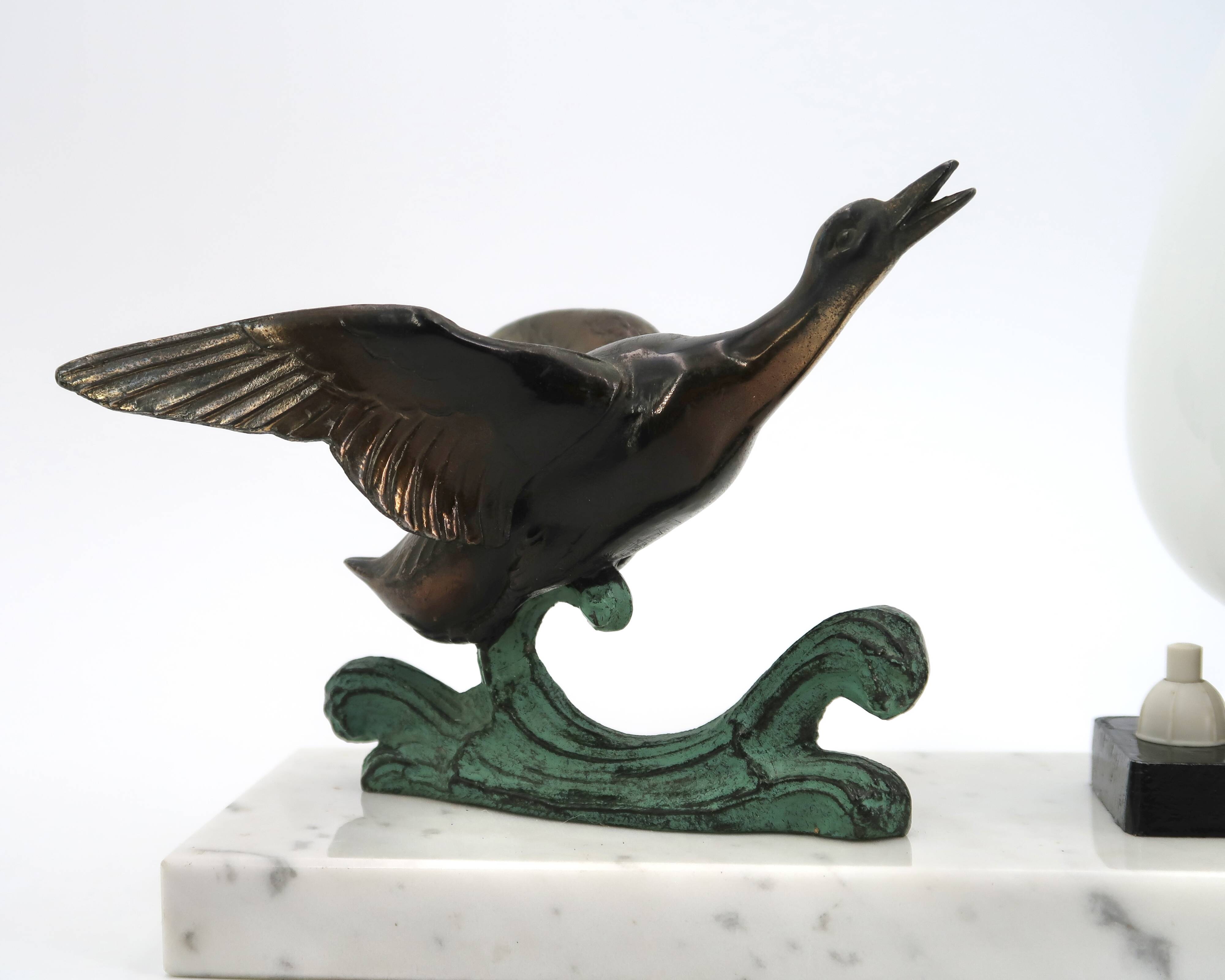Art Deco lamp decorated with a flying duck, marble base, 1930s.