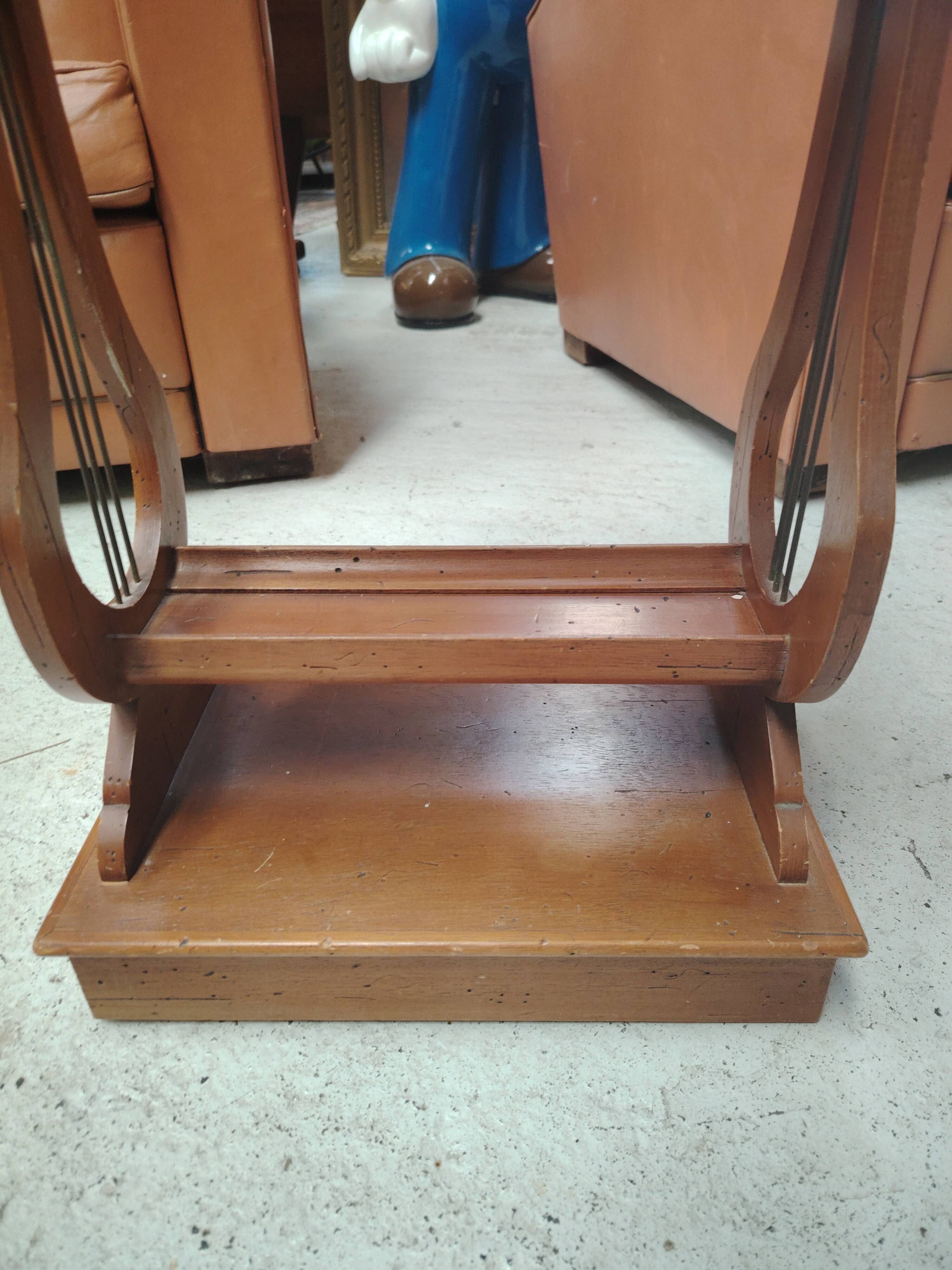 Vintage end table with lyre legs and two drawers.