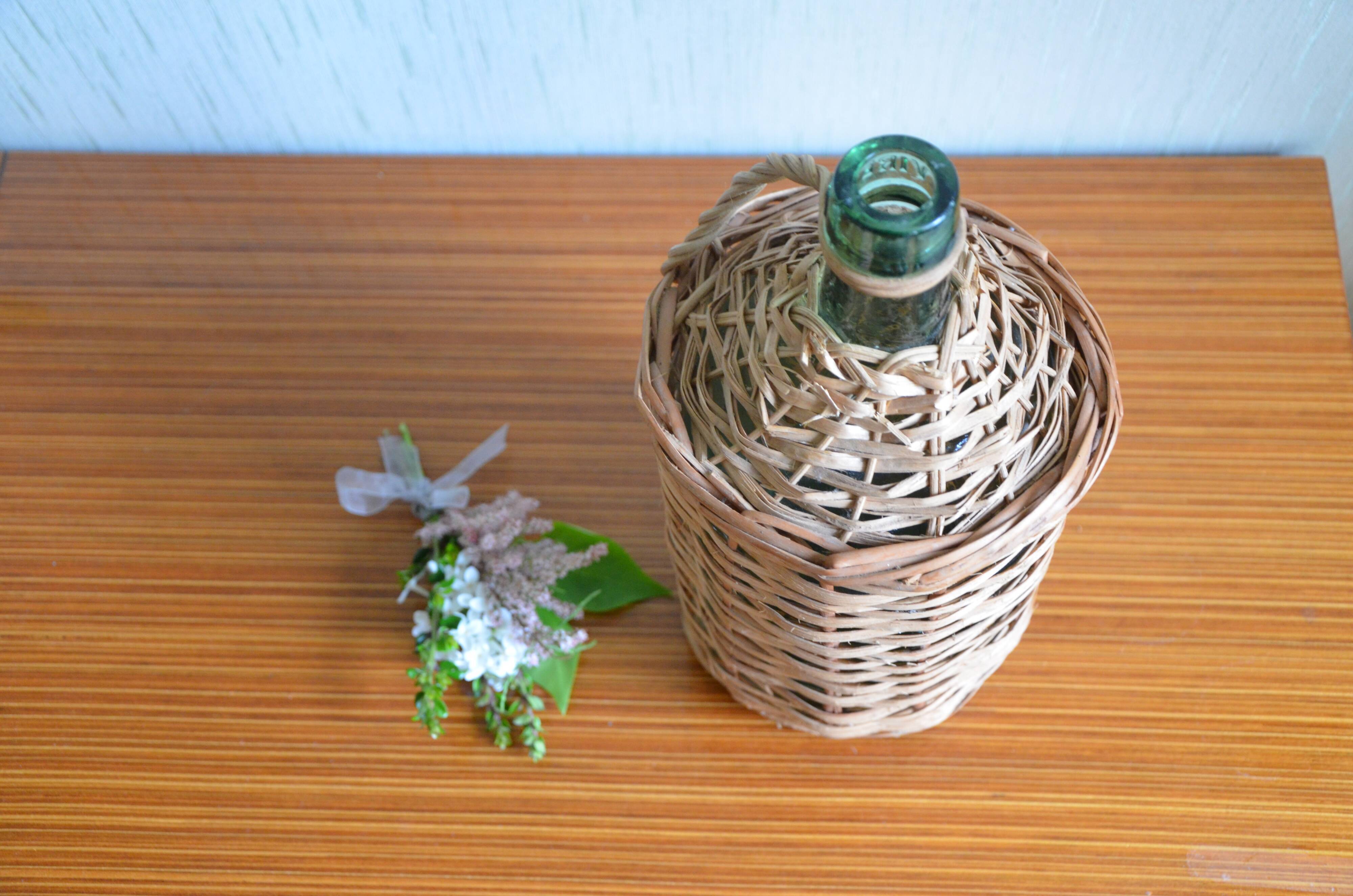 Viresa glass bottle and woven rattan