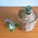 Viresa glass bottle and woven rattan