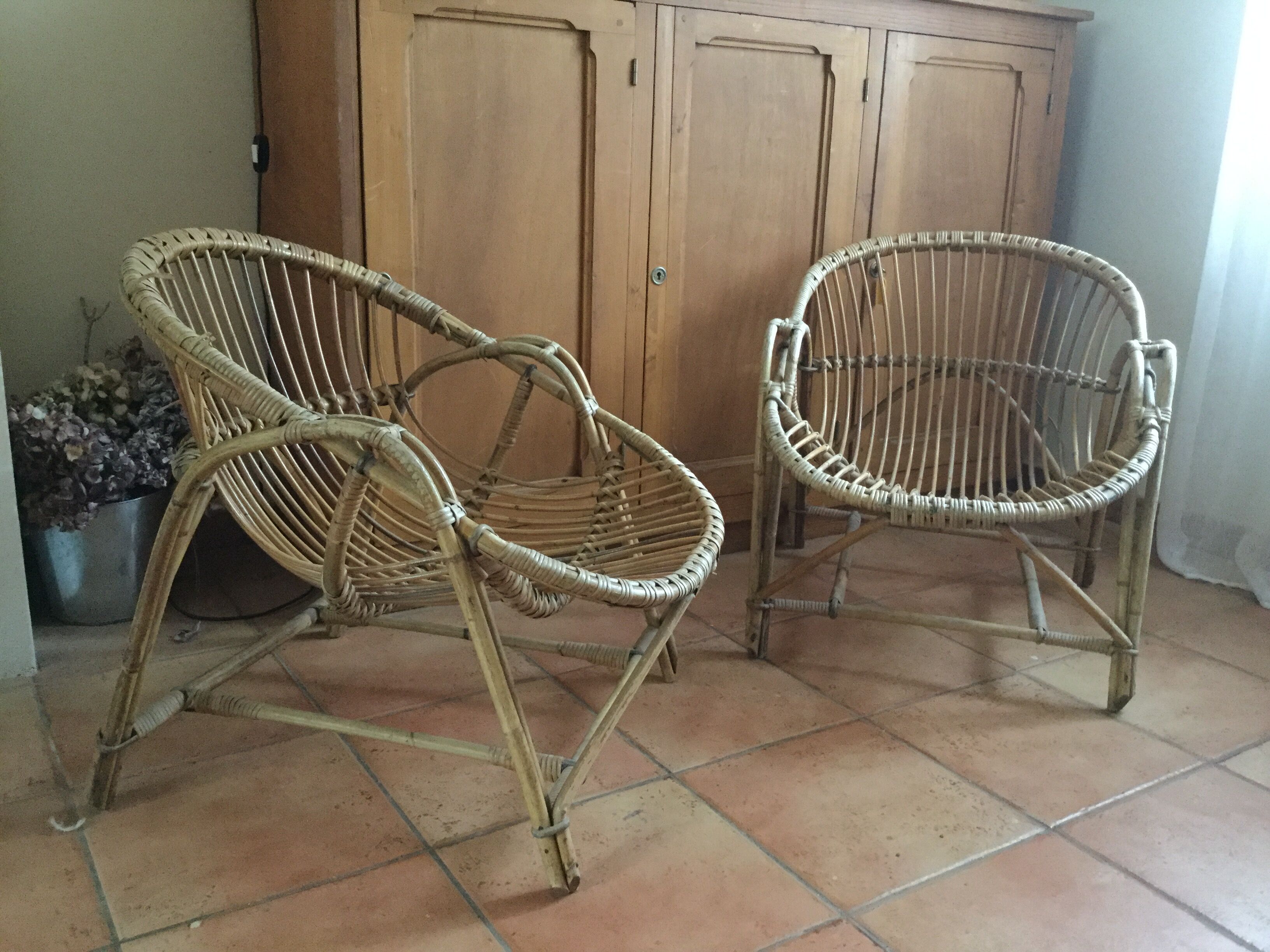 A pair of rattan armchairs