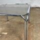 Table basse vintage en métal chromé et verre fumé
