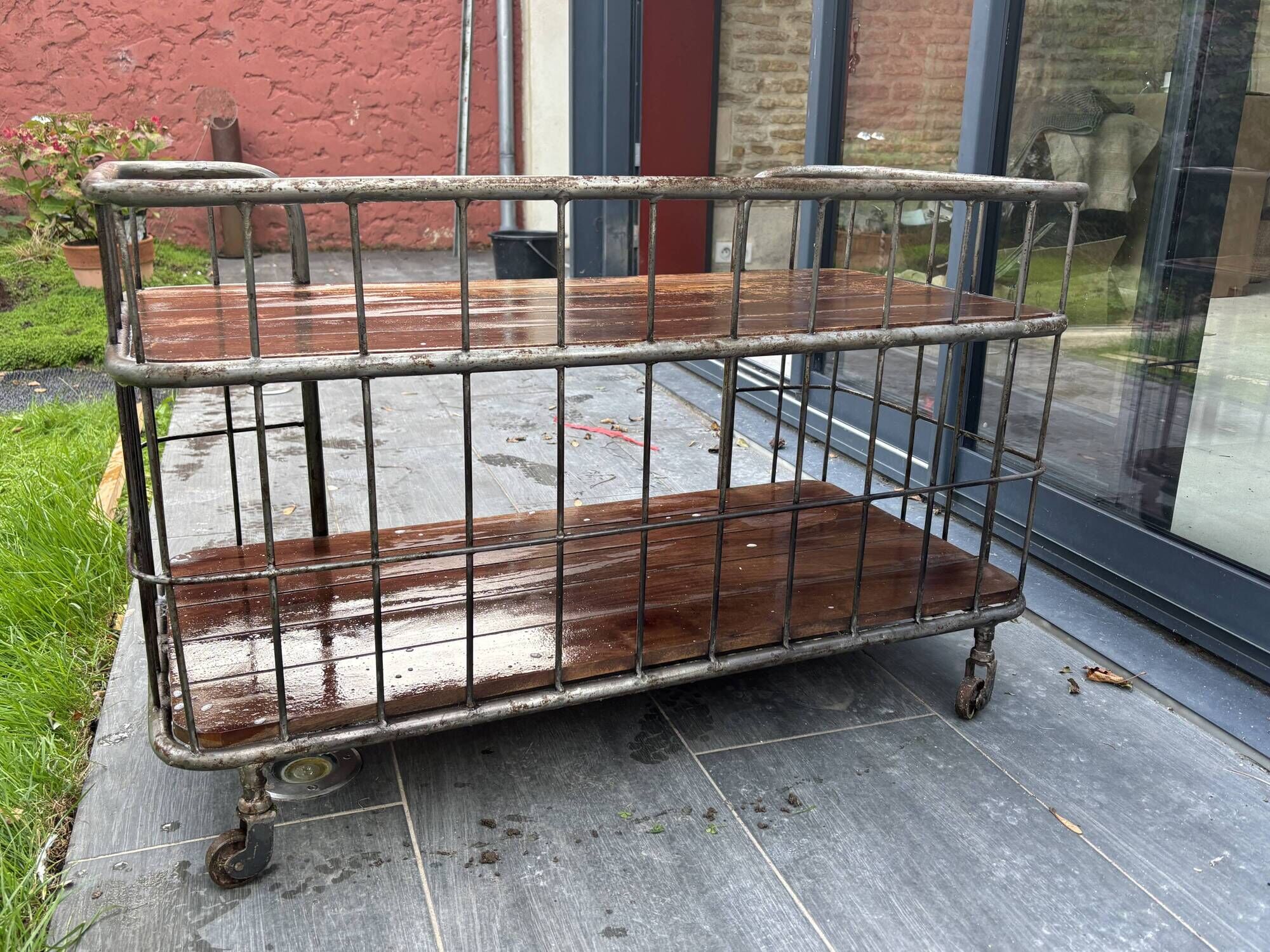 Industrial metal and wood serving trolley on wheels