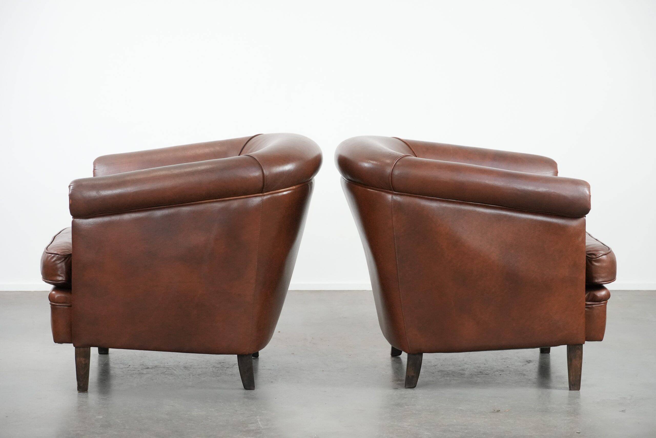 Unique set of two cognac-coloured cow leather club armchairs