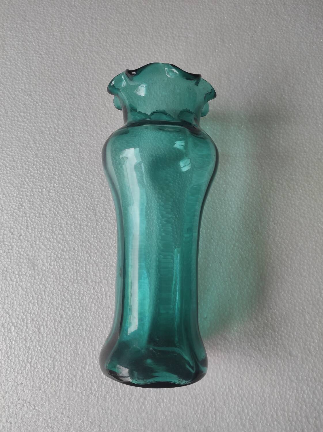 Blown glass vase with a flared neck and wavy rim.