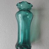 Blown glass vase with a flared neck and wavy rim.