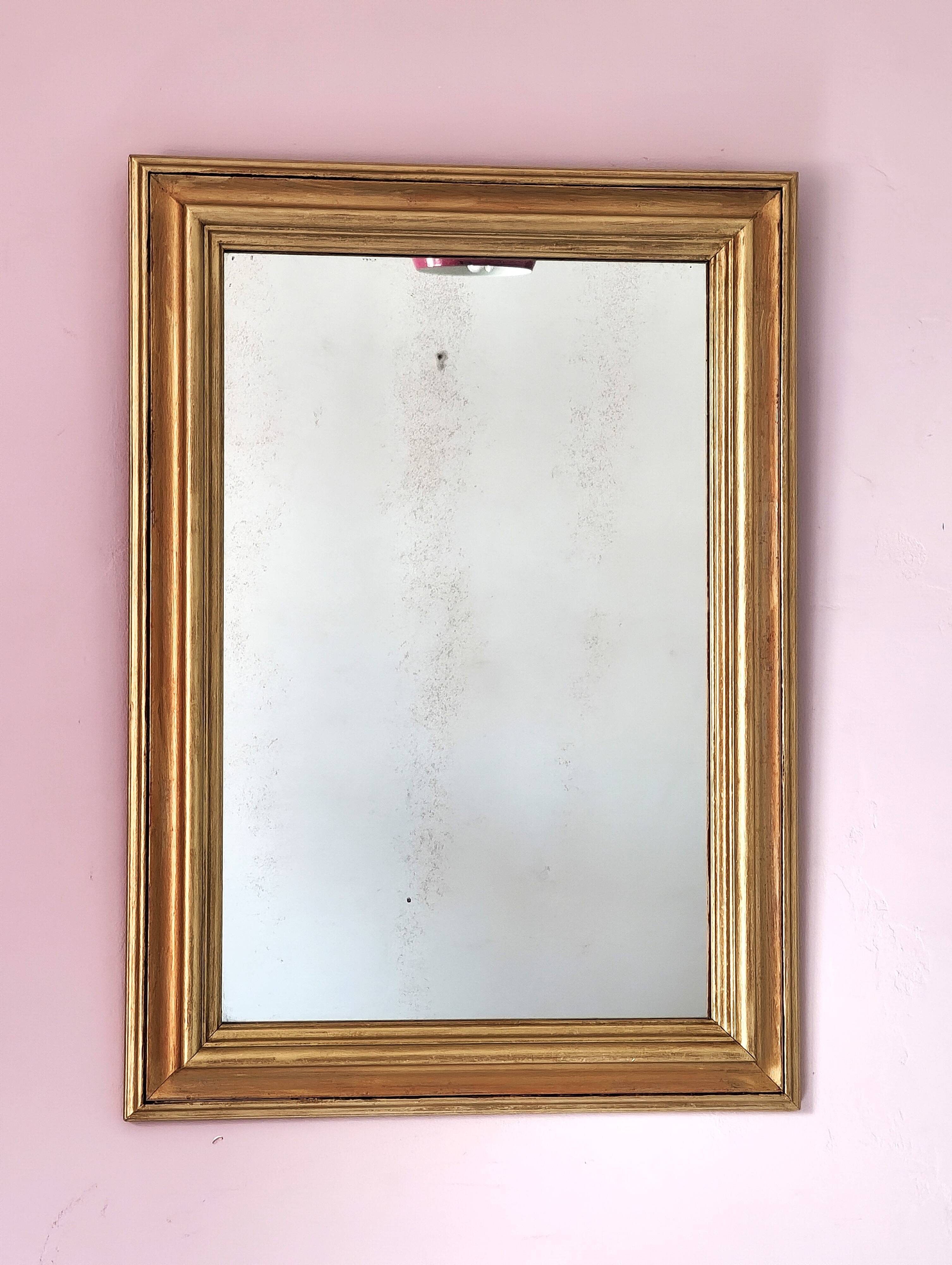 Miroir ancien en bois doré et cuivré