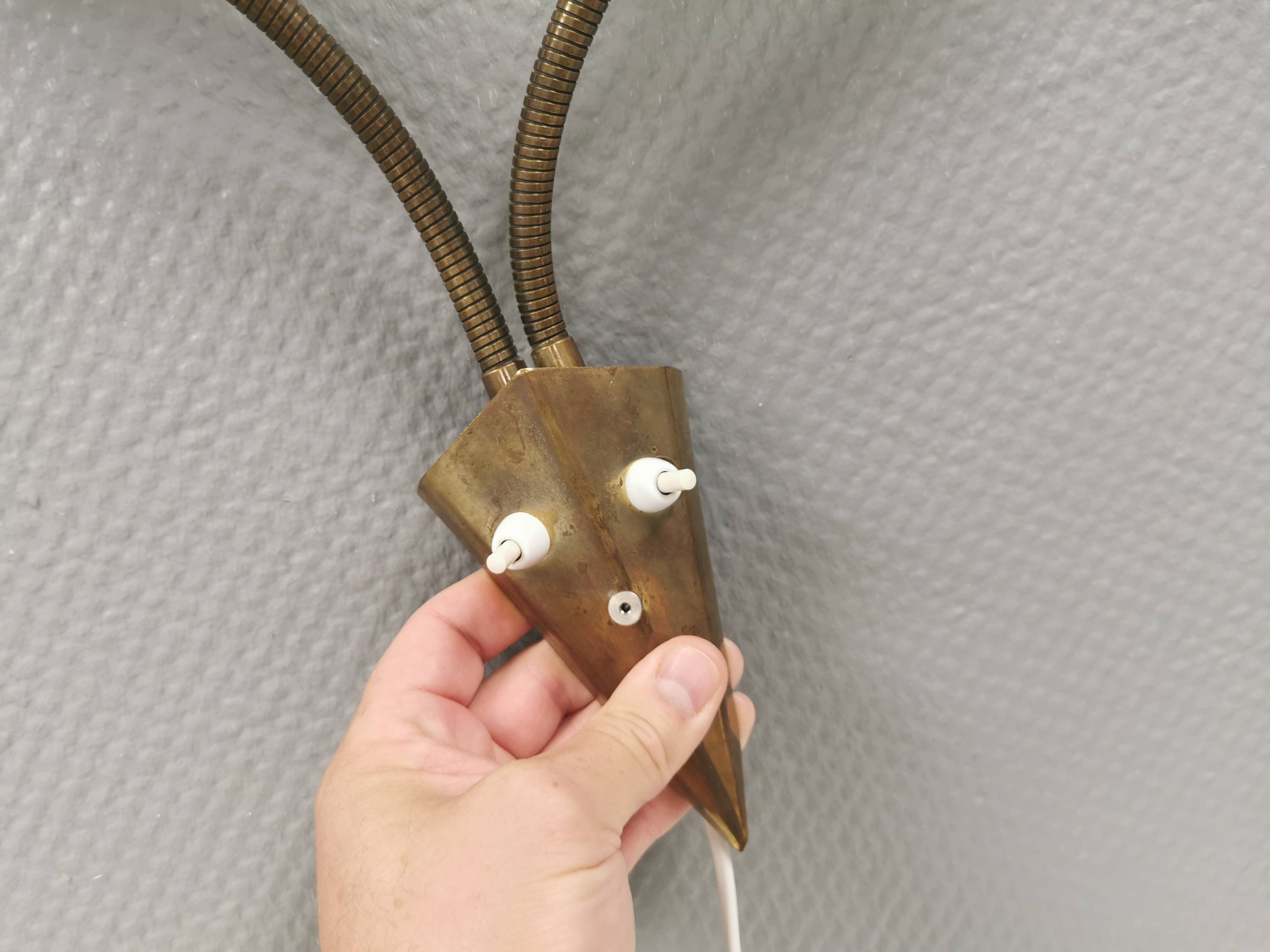 Older wall lamp with black metal shades and brass bend ‘arms’