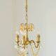 Small vintage brass chandelier with amber crystal pendants.