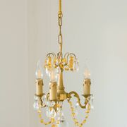 Small vintage brass chandelier with amber crystal pendants.