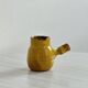 Yellow glazed ceramic sauce boat or milk jug