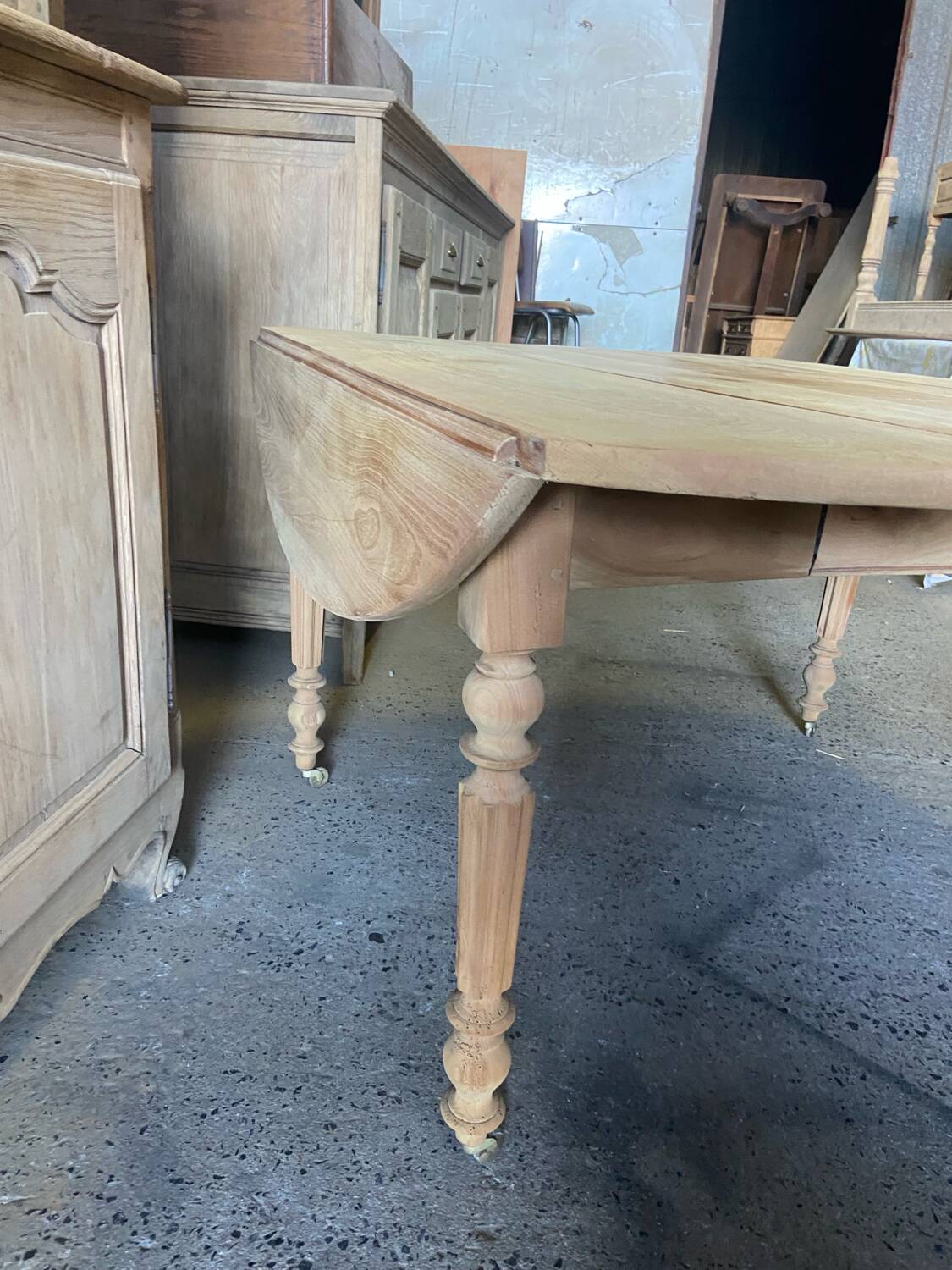 Oval wooden table on wheels.