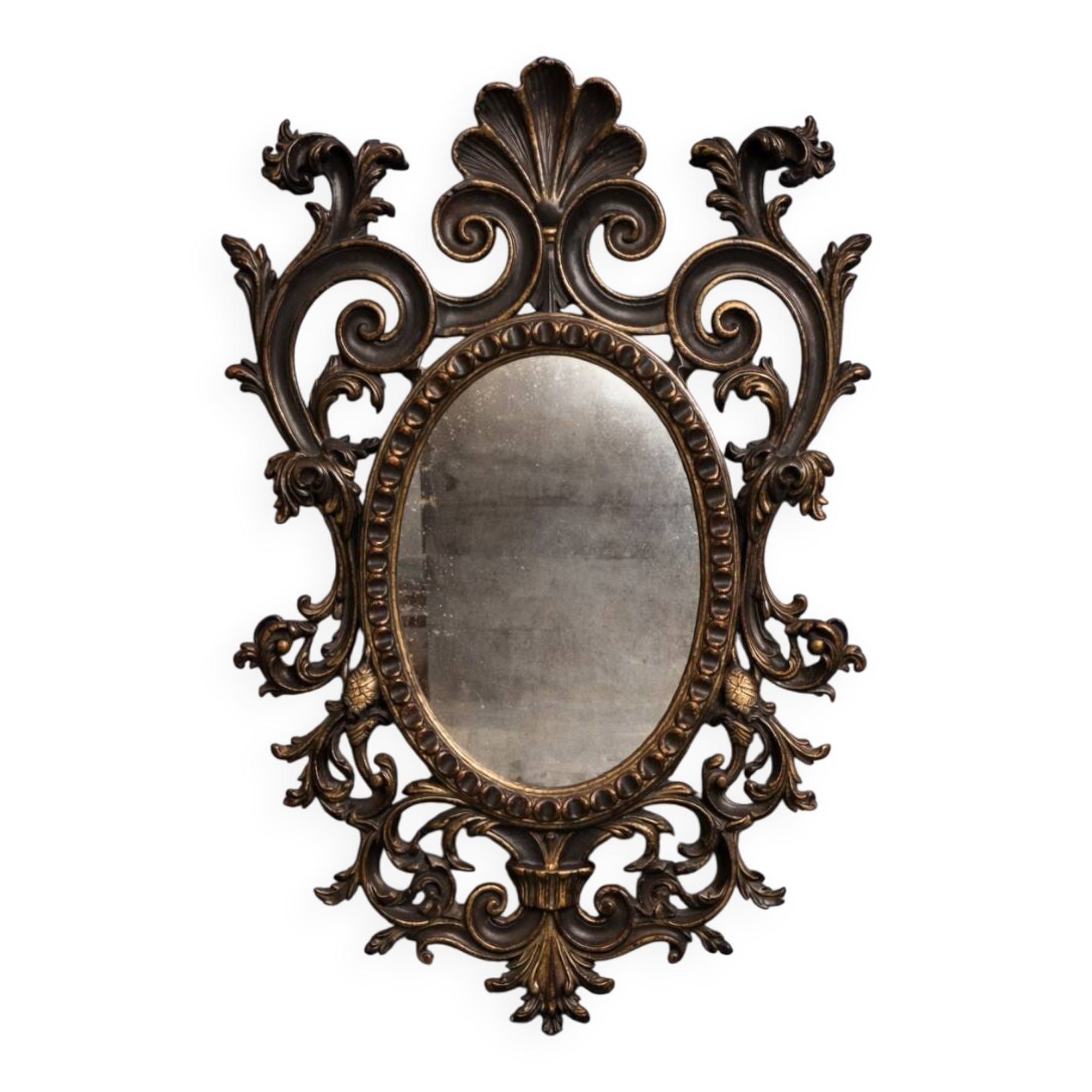 Antique Louis XV style mirror, richly carved with decorations of scrolls, shells, and foliage.