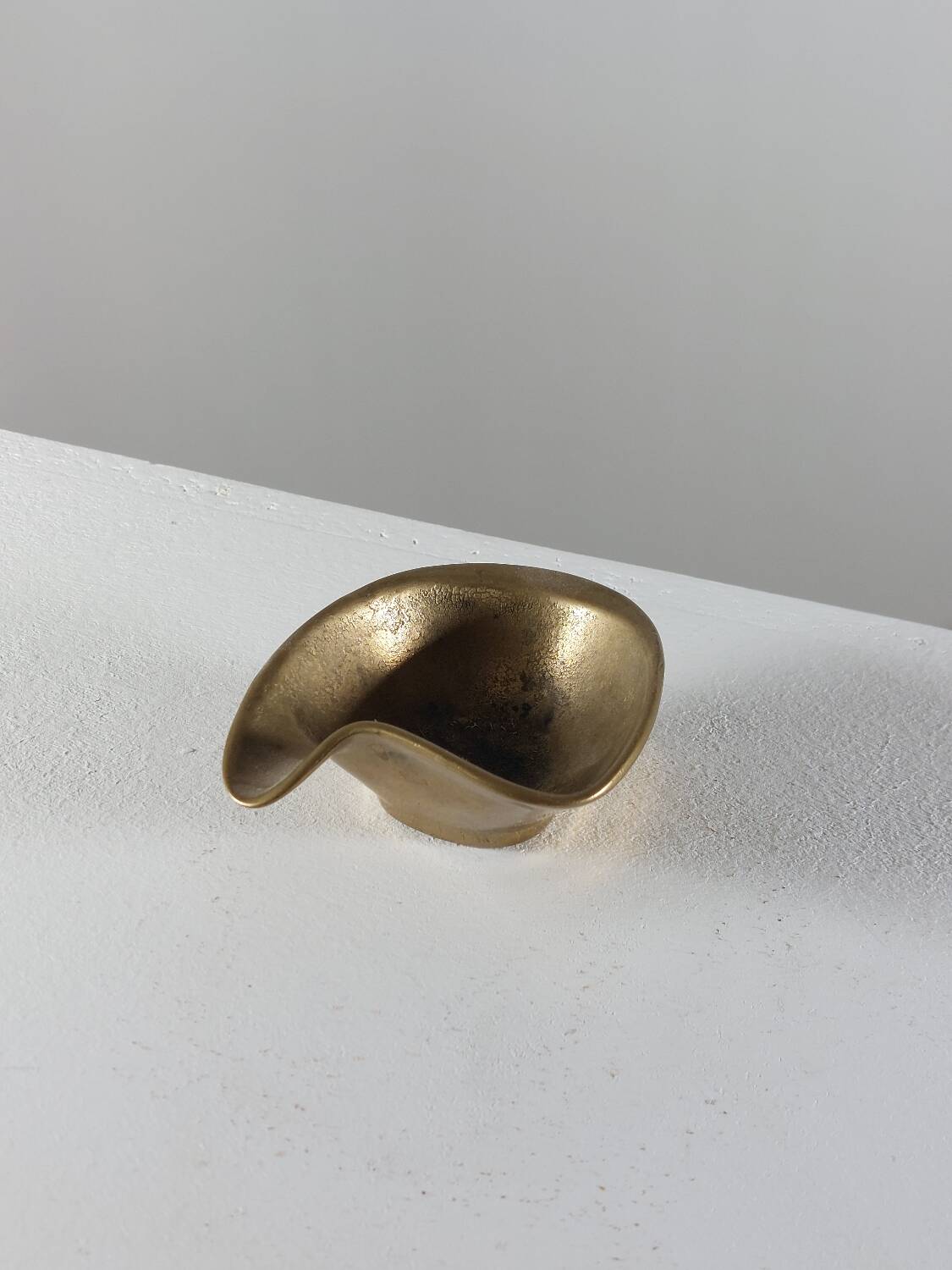 Vintage brass ashtray with an organic design from the 1950s.