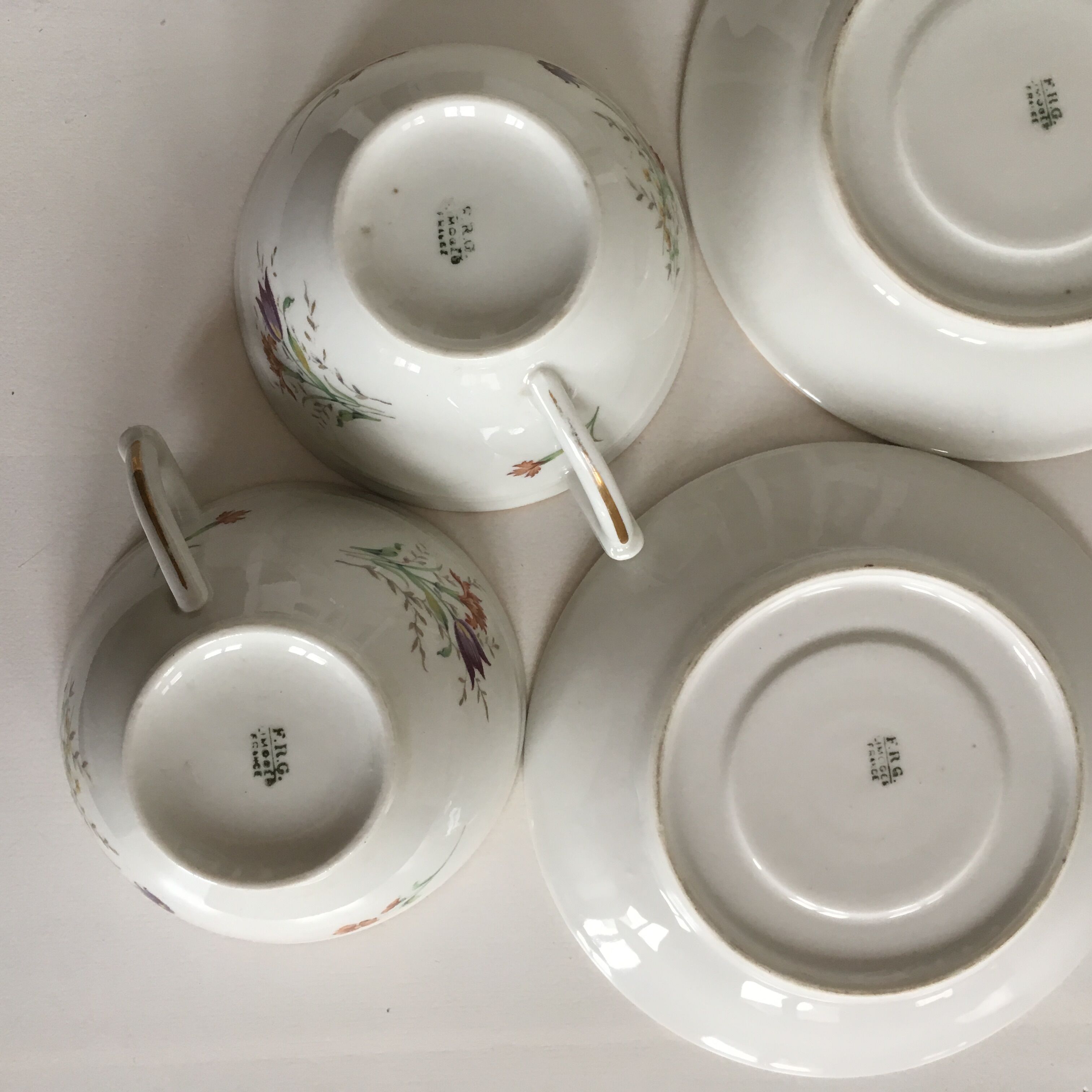 Duo of white Limoges porcelain cups with flowers