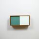 A vintage mid-century wall hung oak cabinet, green & white glass doors