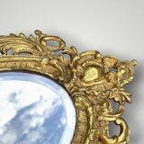 Antique bronze wall sconce with two candlesticks and beveled mirror