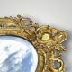 Antique bronze wall sconce with two candlesticks and beveled mirror
