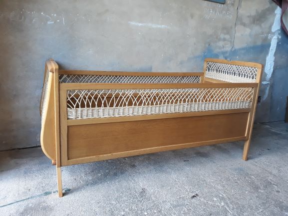 Wooden baby bed and vintage rattan