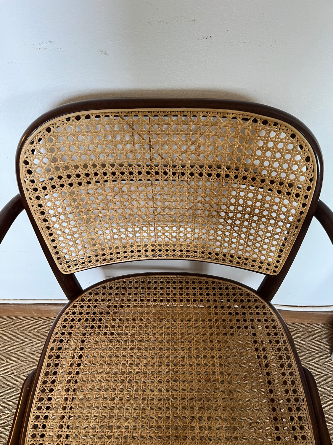 Curved wood and cane armchair