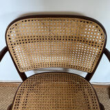 Curved wood and cane armchair