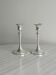 Pair of white metal candlesticks
